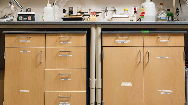 An image of a laboratory counter where each drawer is clearly labeled according to lean 5S laboratory standards. The labels are visible and neatly organized to promote efficiency and ease of access in the lab environment.